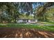 Charming single-story home showcasing a manicured lawn and beautiful mature trees at 1206 Culver Rd, Orlando, FL 32825