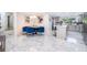 Open-concept kitchen and dining area featuring marble flooring, kitchen island, and modern lighting at 1206 Culver Rd, Orlando, FL 32825