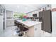 Modern kitchen showcasing the large marble island, pendant lighting, and stainless steel refrigerator at 1206 Culver Rd, Orlando, FL 32825