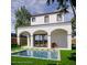 Inviting backyard featuring a covered patio, a sparkling pool, and a well-maintained lawn at 1473 Berkshire Ave, Winter Park, FL 32789