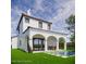 Relaxing backyard with a covered terrace, dining set, lush lawn, and a clear, inviting swimming pool at 1473 Berkshire Ave, Winter Park, FL 32789