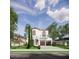 Attractive two-story house displaying an arched entry, balcony, two-car garage, and neat front yard landscaping at 1473 Berkshire Ave, Winter Park, FL 32789