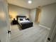 Bedroom with plush bed, bedside tables and lamps with neutral tones and decor at 1526 Hempel Ave, Gotha, FL 34734