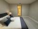 Bedroom with white bedding and dark blue accents and access to the bathroom at 1526 Hempel Ave, Gotha, FL 34734