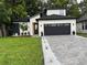 Charming home with a well-manicured lawn, a brick driveway, and a gray two-car garage at 1526 Hempel Ave, Gotha, FL 34734