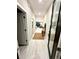 Bright hallway showcases wood floors and access to the living spaces at 1526 Hempel Ave, Gotha, FL 34734