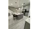 Modern kitchen featuring stainless steel appliances, a kitchen island, and a breakfast bar at 1526 Hempel Ave, Gotha, FL 34734