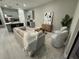 Living room featuring neutral tones, stylish furnishings, and an open layout to the kitchen at 1526 Hempel Ave, Gotha, FL 34734