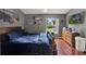 Inviting bedroom with wood floors, ceiling fan, backyard views, and beach-themed decorations at 1709 Kinsman Way, Lakeland, FL 33809