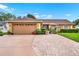 Charming single-story home with a well-maintained front yard, lush landscaping, and a spacious two-car garage at 1709 Kinsman Way, Lakeland, FL 33809