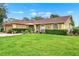 Well-kept home features a green lawn and manicured shrubs enhancing the property's curb appeal at 1709 Kinsman Way, Lakeland, FL 33809