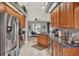 Well-equipped kitchen boasts granite countertops, stainless steel appliances, and wood cabinetry at 1709 Kinsman Way, Lakeland, FL 33809