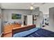Relaxing bedroom with hardwood floors, a ceiling fan, and a view into the ensuite bath at 1709 Kinsman Way, Lakeland, FL 33809