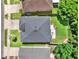 Aerial view of home with a gray roof, concrete patio, and a well-maintained lawn at 1712 Riveredge Rd, Oviedo, FL 32766