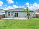 Exterior of house shows grassy backyard and covered patio at 1712 Riveredge Rd, Oviedo, FL 32766
