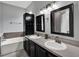 Modern bathroom with double sinks, a vanity, decorative mirrors, and a soaking tub at 1712 Riveredge Rd, Oviedo, FL 32766