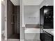 Bathroom featuring a tiled shower with a built-in bench and a tub with black cabinets at 1712 Riveredge Rd, Oviedo, FL 32766