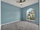 Bedroom featuring a ceiling fan, carpeted floors, and a large window at 1712 Riveredge Rd, Oviedo, FL 32766