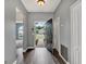 Bright and spacious foyer with wood-look flooring, neutral paint, and an open doorway to the living area at 1712 Riveredge Rd, Oviedo, FL 32766