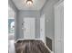 Entrance foyer with wood-look flooring, light gray walls, and a white front door with decorative molding at 1712 Riveredge Rd, Oviedo, FL 32766