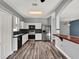 Spacious kitchen with stainless steel appliances, dark countertops and backsplash, and wood-look floors at 1712 Riveredge Rd, Oviedo, FL 32766