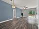 Bright living room with wood-look flooring, a blue accent wall, and modern lighting fixtures at 1712 Riveredge Rd, Oviedo, FL 32766