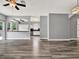 Inviting living room with wood-look flooring, an open view to the kitchen, and plenty of natural light at 1712 Riveredge Rd, Oviedo, FL 32766