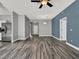 Open-concept living room featuring wood-look floors and neutral walls, perfect for entertaining or relaxation at 1712 Riveredge Rd, Oviedo, FL 32766