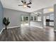 Spacious living area with wood-look flooring, a sliding glass door, and an open view to the kitchen at 1712 Riveredge Rd, Oviedo, FL 32766