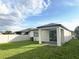 A home backyard with a covered patio and green grass at 17504 Butterfly Pea Ct, Clermont, FL 34714
