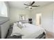 Comfortable primary bedroom with a ceiling fan, gray queen size bed, and attached bathroom at 17504 Butterfly Pea Ct, Clermont, FL 34714