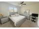 Bedroom featuring large window, ceiling fan, queen bed, dresser, and desk at 17504 Butterfly Pea Ct, Clermont, FL 34714