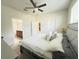 Spacious bedroom with ceiling fan and en-suite bathroom with neutral paint at 17504 Butterfly Pea Ct, Clermont, FL 34714
