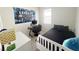 A well-lit bedroom features a gaming setup, a cozy bed, and a window for natural light at 17504 Butterfly Pea Ct, Clermont, FL 34714