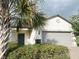 Charming single-story home featuring a well-maintained lawn and attached two-car garage with a brick-paved driveway at 17504 Butterfly Pea Ct, Clermont, FL 34714