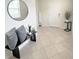 Inviting foyer with neutral tile flooring, a stylish round mirror, and a contemporary console table with decorative accents at 17504 Butterfly Pea Ct, Clermont, FL 34714