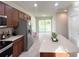 Well-lit kitchen featuring stainless steel appliances, a center island, and sliding glass doors to the backyard at 17504 Butterfly Pea Ct, Clermont, FL 34714