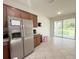 Efficient kitchen featuring stainless steel appliances, classic cabinetry, and easy access to the outdoor area at 17504 Butterfly Pea Ct, Clermont, FL 34714