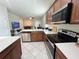 Open-concept kitchen with stainless steel appliances, ample counter space, and a view into the adjacent living area at 17504 Butterfly Pea Ct, Clermont, FL 34714