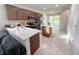 Modern kitchen featuring stainless steel appliances, a center island, and ample counter space with adjacent living area at 17504 Butterfly Pea Ct, Clermont, FL 34714