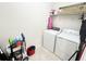 Efficient laundry room featuring a washer, dryer, and shelving for organized storage at 17504 Butterfly Pea Ct, Clermont, FL 34714