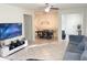 Open-concept living room featuring neutral tile flooring, comfortable seating, and a dining area with elegant lighting at 17504 Butterfly Pea Ct, Clermont, FL 34714