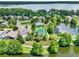 An aerial view showing the community tennis courts, pool, landscaping and a lake at 211 Tavestock Loop, Winter Springs, FL 32708