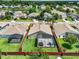 A fenced in backyard featuring a screened in patio with a hot tub and patio furniture at 211 Tavestock Loop, Winter Springs, FL 32708