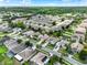 An aerial view of the neighborhood shows the tree lined streets and well maintained homes at 211 Tavestock Loop, Winter Springs, FL 32708