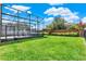 A lush green yard features an enclosed patio with a hot tub at 211 Tavestock Loop, Winter Springs, FL 32708