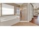 Bright bathroom featuring a soaking tub and separate glass-enclosed shower at 211 Tavestock Loop, Winter Springs, FL 32708