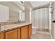 Bathroom with a granite-topped vanity and a shower with a curtain at 211 Tavestock Loop, Winter Springs, FL 32708