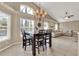 Open-plan view of the dining area with vaulted ceilings flowing into the living area at 211 Tavestock Loop, Winter Springs, FL 32708