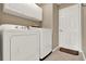 Laundry room with white appliances and cabinets for storage space at 211 Tavestock Loop, Winter Springs, FL 32708